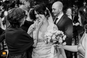   Moments after the ceremony at Castello di Macello, Italy, the bride shares an intimate, emotional pause with a family member.